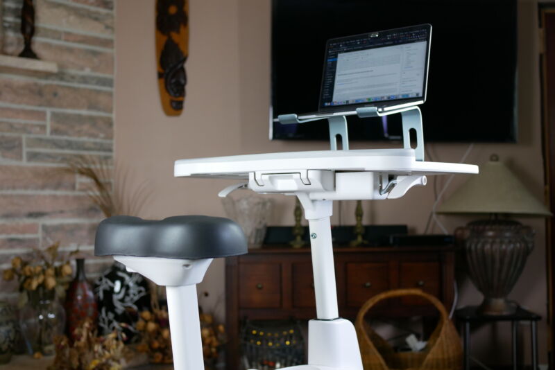 the bike seat and desktop of the desk bike with a laptop and wireless keyboard on top