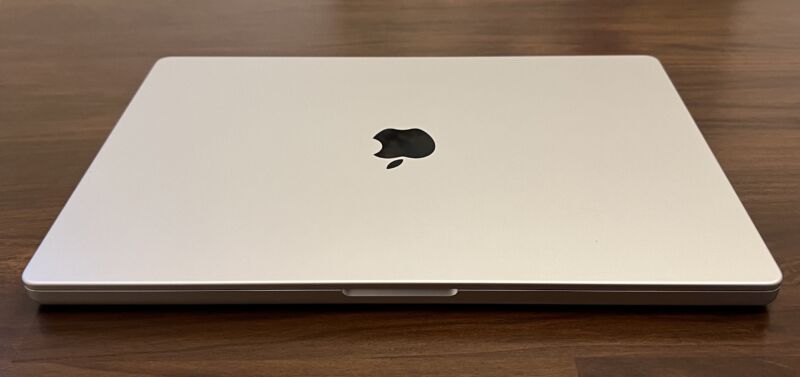 The front of a closed, silver-colored laptop on a table
