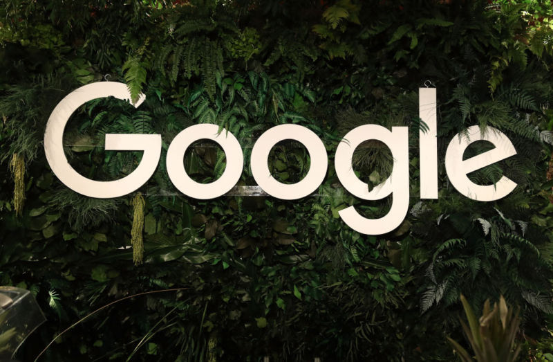 A large Google logo is displayed amidst foliage.
